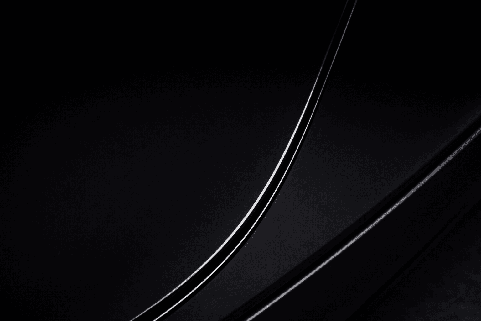 Macro close-up of the same black painted surface with a smooth glossy finish